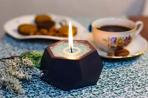 Burning candle on the table Stock Photos
