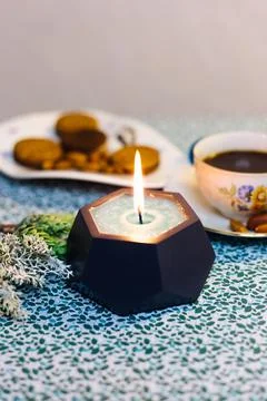 Burning candle on the table Stock Photos