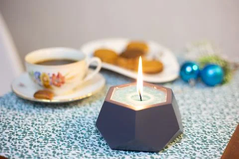 Burning candle on the table Stock Photos