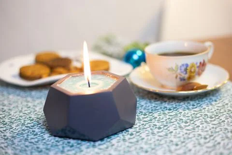 Burning candle on the table Stock Photos