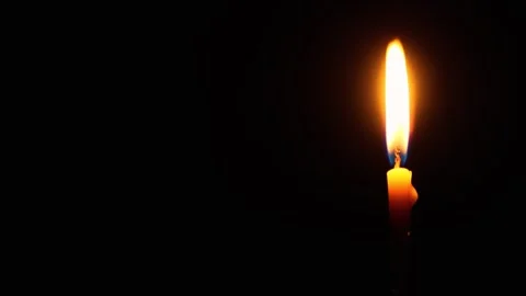 A burning candle in total darkness. The concept of religion, grief and memory. Stock Footage 290070084