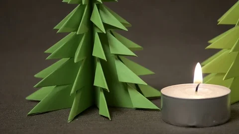 Burning candle with two origami tree Stock-Footage 69861452
