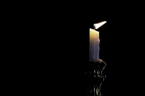 Burning candle on a white background Stock Photos
