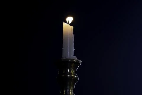Burning candle on a white background Stock Photos