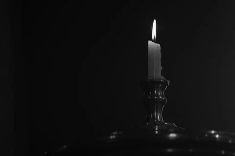 Burning candle on a white background Stock Photos