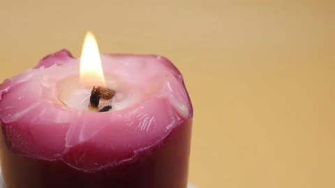 Burning candle on a yellow background Stock-Footage 169943498