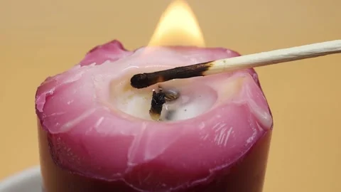 Burning candle on a yellow background Stock Footage 169943593