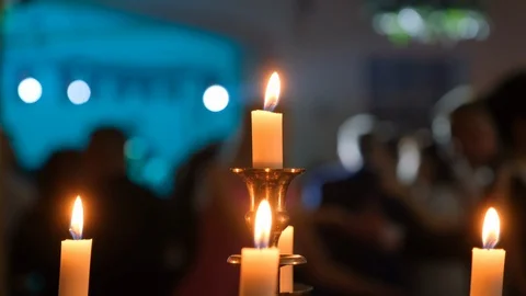 Burning candles against the background of dancing people Stock Footage 104918940