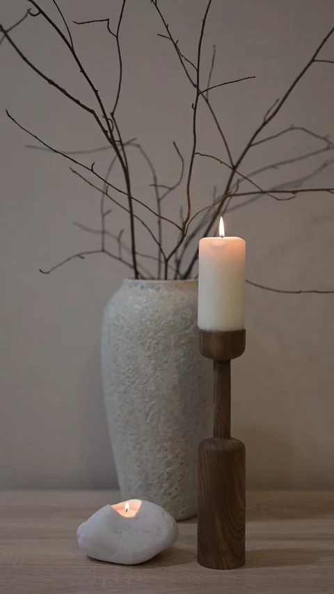 Burning candles and bare branches creating a cozy atmosphere Vídeo Stock 308260300