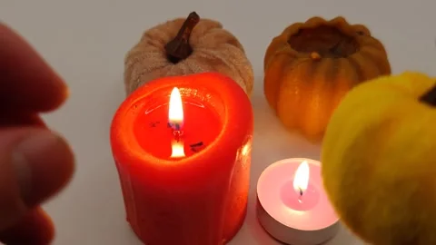 Burning candles and pumpkins, top view. Halloween holiday decor. Stock Footage 319789880