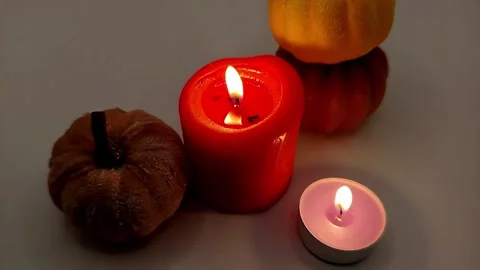 Burning candles and pumpkins, top view, dim light. Halloween decor. Stock Footage 319789921