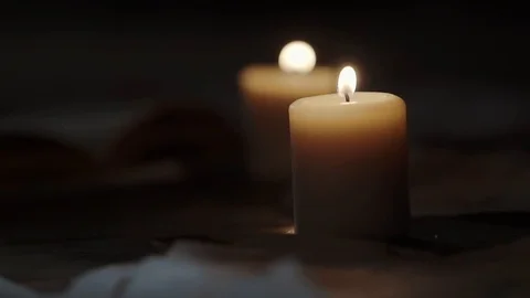 Burning candles are standing on floor in dark hall, scaring shadows are moving Video stock 88409183