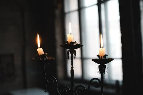 Burning candles on a candlestick Stock Photos