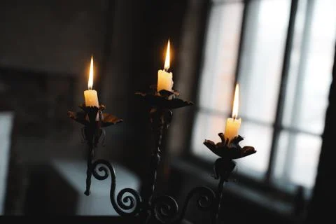 Burning candles on a candlestick Stock Photos