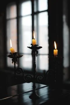 Burning candles on a candlestick Stock Photos