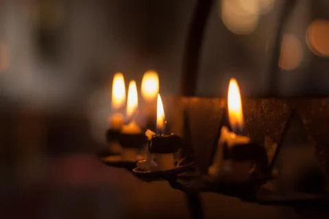 Burning candles on a candlestick Stock Photos