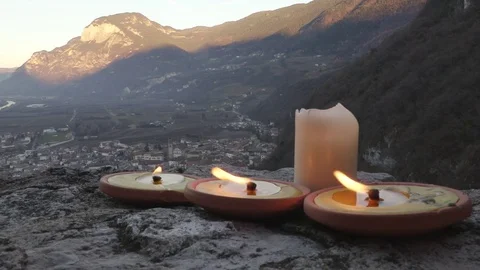 Burning Candles on Castle Wall over Alpine Town at December Sunset Video stock 70221607