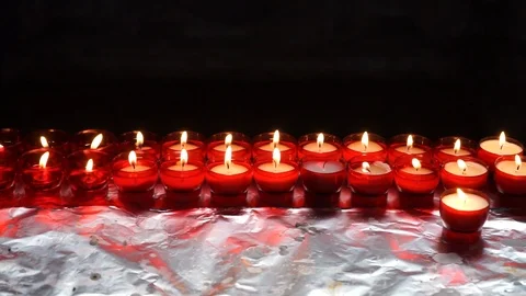 Burning candles in a Catholic or Protestant temple, with the dark background Stock Footage 107910098