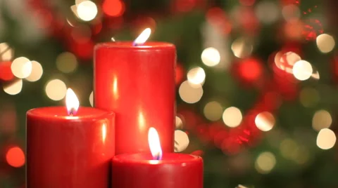 Burning candles, with Christmas tree in background Video stock 62282545