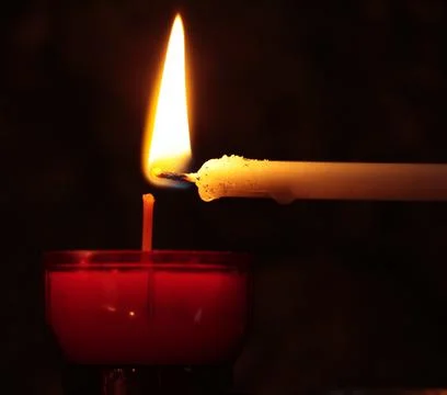 Burning candles on dark surface. Memory day Stock Photos