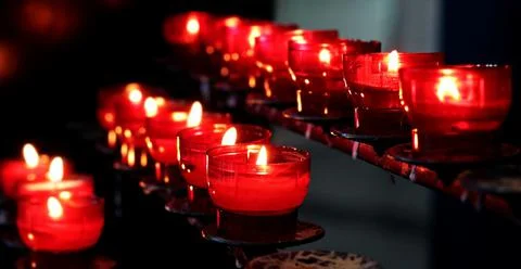 Burning candles on dark surface. Memory day Stock Photos