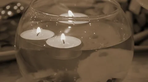 Burning candles floating in a decorative vase retro filtered Stock Footage 62407481