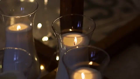 Burning candles on the floor in the dark. Concept. candles in glass candlesticks Stock Footage 147506692