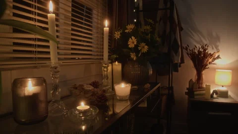 Burning Candles with Flowers under Flickering Light in Cozy Room Interior Stock Footage 341675555