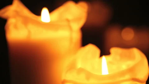 Burning candles in front of black background Stock Footage 242423614