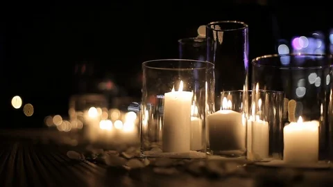 Burning candles in glass flasks. Large candles burn in glass flasks. hall Stock Footage 120702222