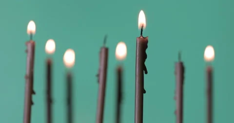 Burning a candles on green background Video stock 143126253