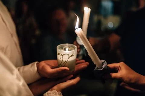 Burning candles in hands 스톡 사진