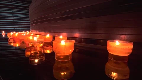 Burning candles illuminate the church with a warm light Stock Footage 274365853