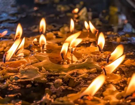 Burning candles in memory of the dead. Melted wax from candles Fotos de archivo