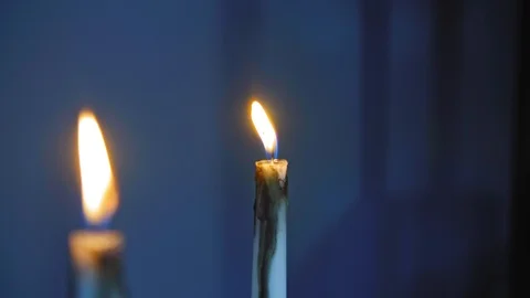 Burning candles over blue background 4K Stock Footage 99603155