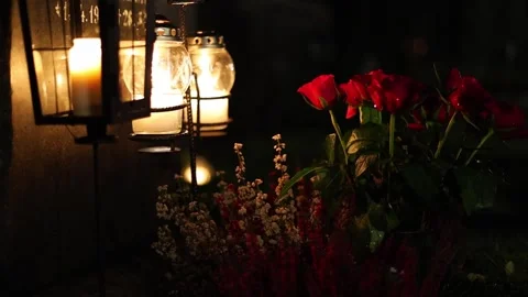 Burning candles placed on graves in a quiet cemetery, 4K ultra HD. Stock Footage 320640659