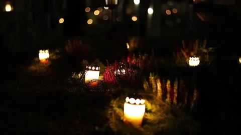Burning candles placed on graves in a quiet cemetery, 4K ultra HD. Stock-Footage 320640660