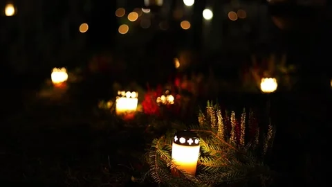 Burning candles placed on graves in a quiet cemetery, 4K ultra HD. Stock Footage 320640696