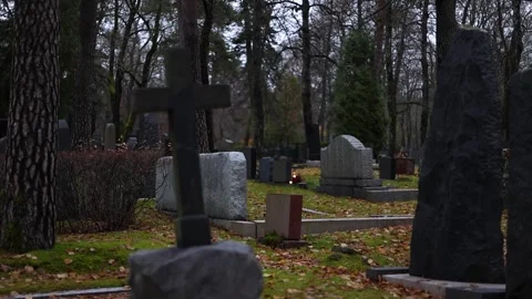 Burning candles placed on graves in a quiet cemetery, 4K ultra HD. Stock Footage 320640999
