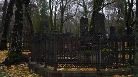 Burning candles placed on graves in a quiet cemetery, 4K ultra HD. Stock Footage 320641434