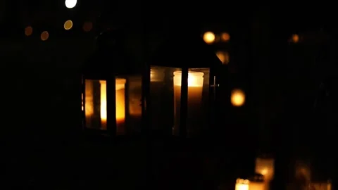 Burning candles placed on graves in a quiet cemetery, 4K ultra HD. Stock Footage 320643241