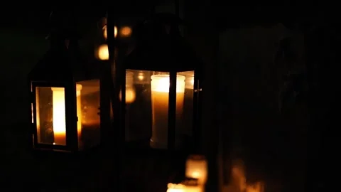 Burning candles placed on graves in a quiet cemetery, 4K ultra HD. Stock Footage 320643293