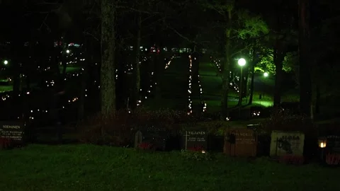 Burning candles placed on graves in a quiet cemetery, 4K ultra HD. Stock-Footage 320643296