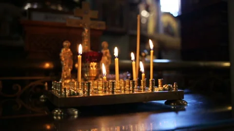 Burning candles in sconces on black blue background Stock Footage 65957880