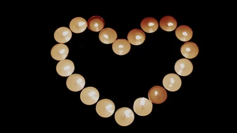 Burning candles shape heart Stock Footage 72234356