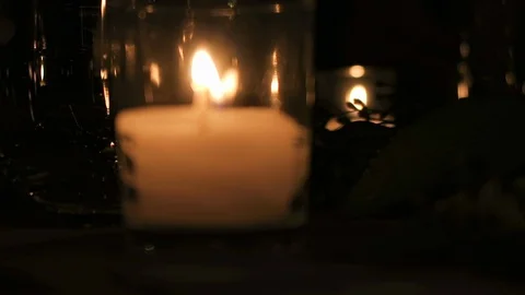 Burning candles sit on an outdoor ￼table￼ for the evenings event￼￼. Stock Footage 119078705