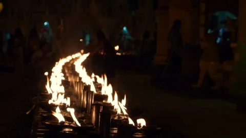 Burning candles sitting in a row Stock Footage 336382615