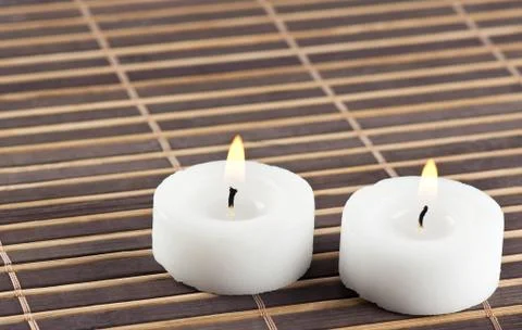 Burning candles on table Stock Photos