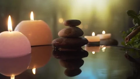 Burning candles in the water, the reflection of stones on the background  Stock Footage 130654049