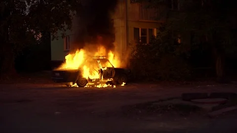 Burning car close to a house in a sleeping area of city Stock Footage 117929981